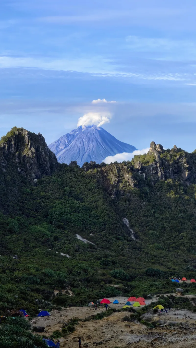 Tents at the crater camp with Mount Sinabung steaming in the background