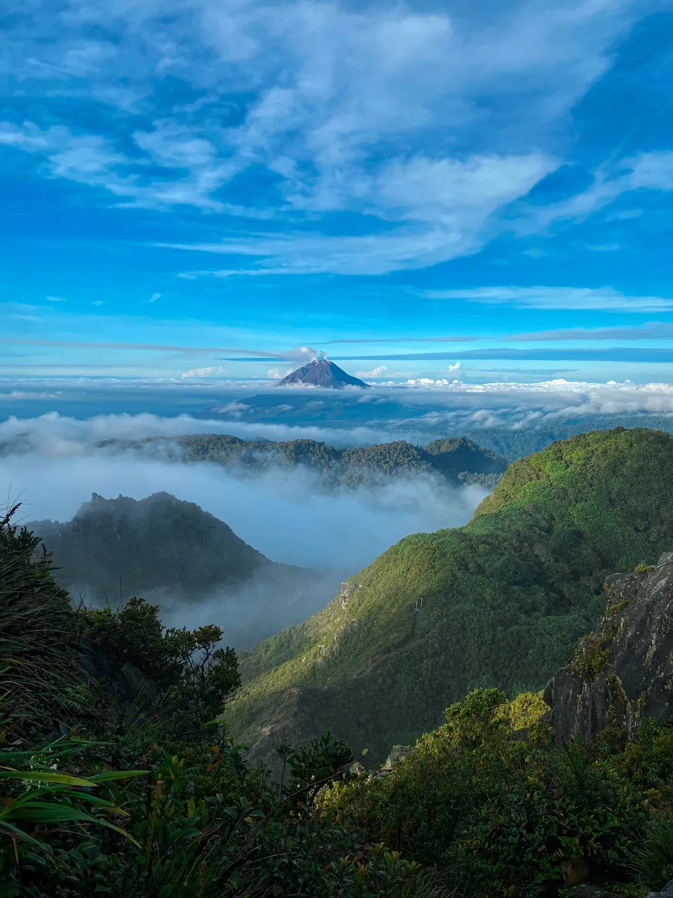 Clouds rolling over the highlands toward Mount Sinabung before dawn