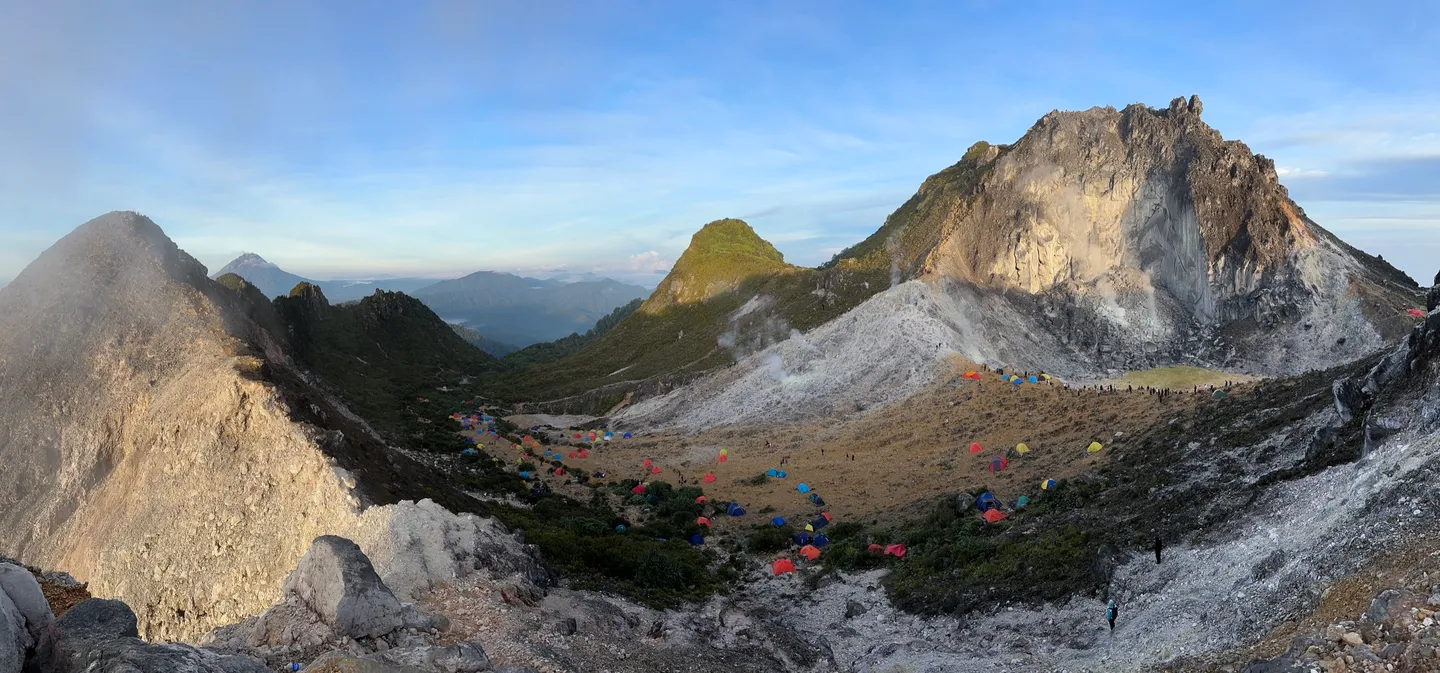 Panorama of the Mount Sibayak caldera with camps on the crater rim