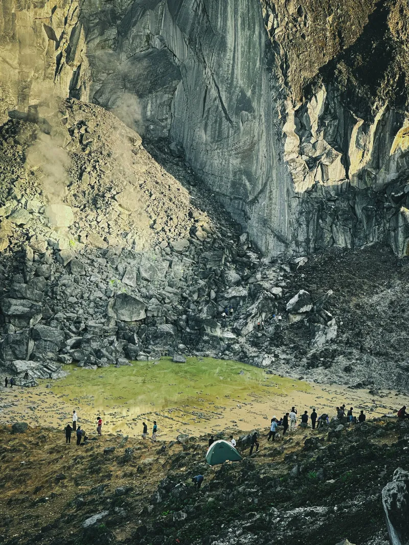 Trekkers crossing the crater wall of Mount Sibayak