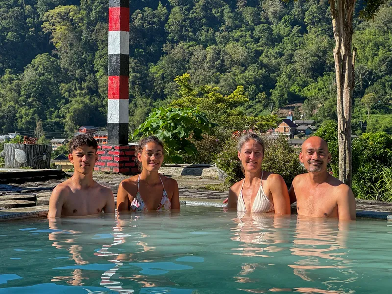 Visitors soaking in the volcanic hot springs near Berastagi