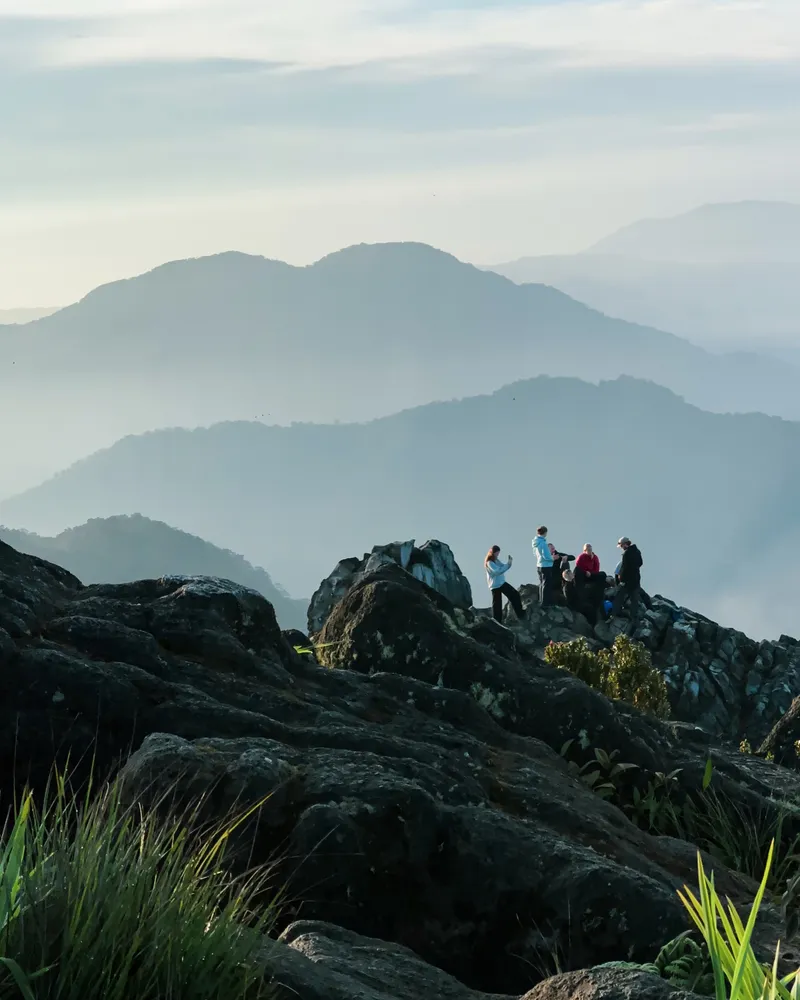 Trekkers at the Mount Sibayak summit in morning mist