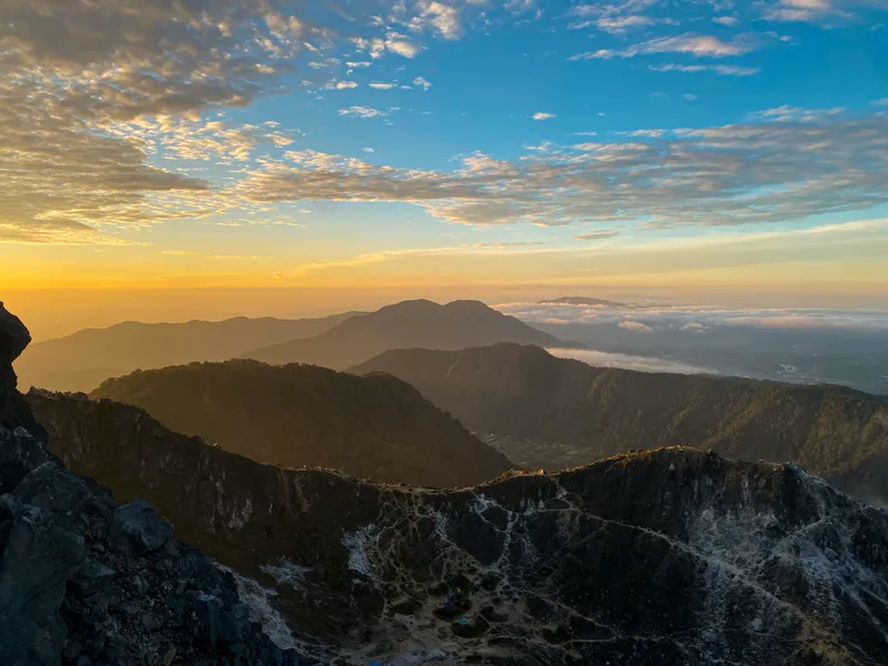 The summit ridge of Mount Sibayak above the clouds at sunrise